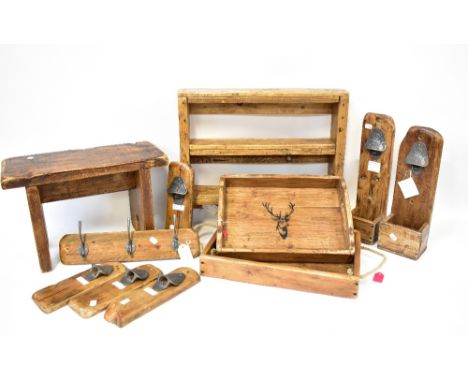 Various hand made stained wooden items comprising two galleried trays with stag's head decoration, three wall-hanging coat ra