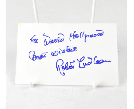 ROBERT LUDLUM; a piece of card bearing the author's signature with presentation inscription.We have not authenticated this si