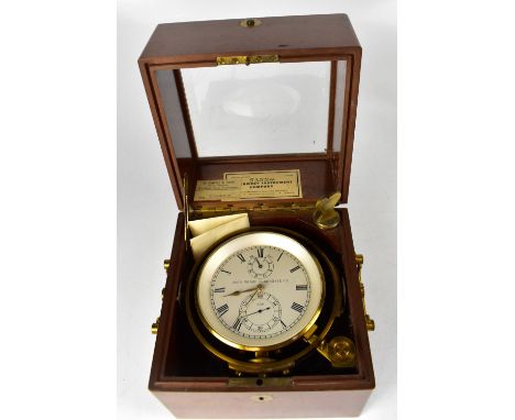 An early 20th century cased and gimbal mounted marine chronometer, the silvered dial set with Roman and Arabic numerals and i