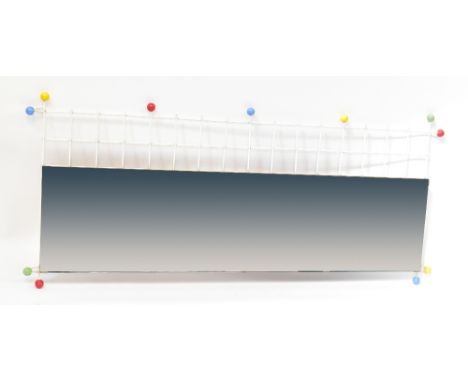 A 1970s/80s pop culture decorative mirror, the long rectangular plain mirror held with end caps mounted on white plastic coat