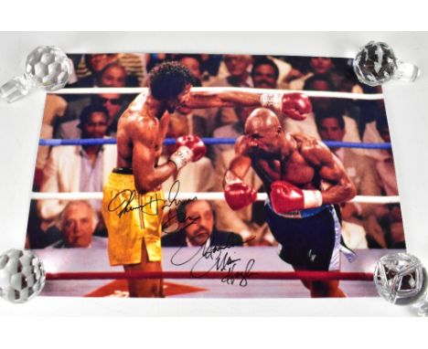 BOXING; four reproduction colour photographs depicting Marvelous Marvin Hagler and Thomas 'The Hitman' Hearns, each bearing s