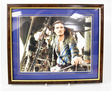 FILM; a group of ten autographed stock pictures of stars of stage and screen, to include Orlando Bloom, Clint Eastwood (first