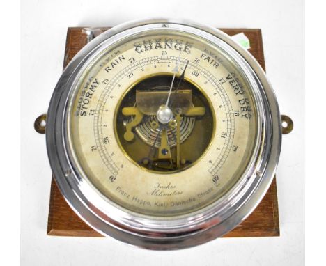 An early 20th century German ship's bulkhead barometer inscribed to the silvered dial 'Franz Happe Kiel, Dänische Strass 2.',