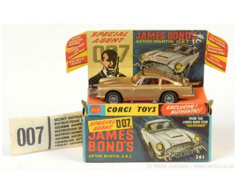 Corgi 261 "James Bond" Aston Martin DB5 taken from the film "Goldfinger" - gold body, red interior with "James Bond" figure, 