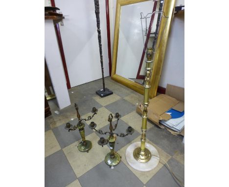 A small onyx and brass standard lamp and a pair of onyx and brass candlesticks 