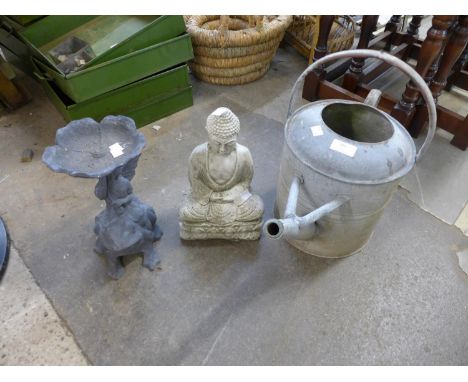A galvanised watering can, concrete deity figure and a small figural cast iron planter 