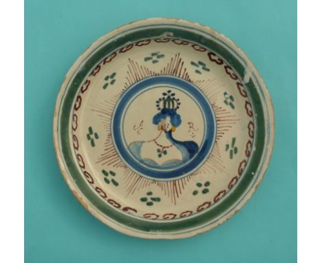 Queen Anne: a rare polychrome Delf dish, possible London, painted in brown, green and yellow with a central portrait medallio