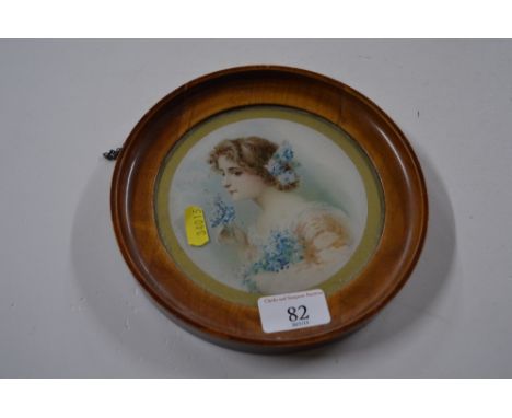 A miniature portrait print of a young lady with flowers in her hair