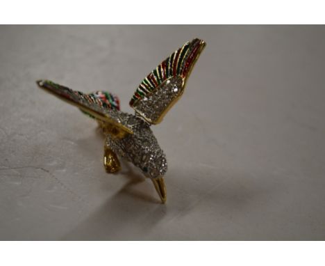 A white stone and enamel bird brooch