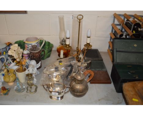 A plated three piece teaset; a plated Guernsey jug; brass table lamp; an oil lamp etc.