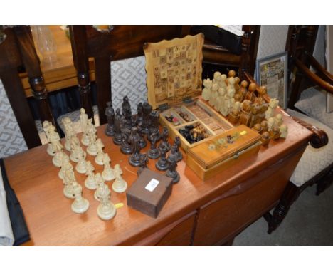 A quantity of chess pieces, games box and contents, draughts set etc. 