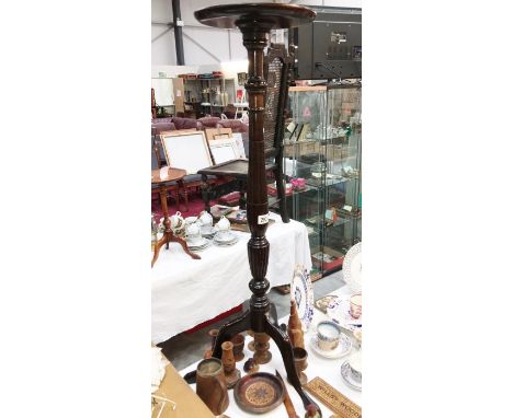 A tall mahogany tripod torchere wine/plant stand