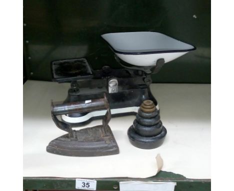 A set of scales with weights & an old iron