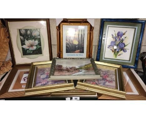 A shelf of frames & pictures