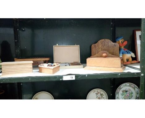 A shelf of wooden items including camel solitaire board