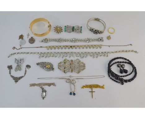 A collection of antique and later jewellery including paste set pendants, brooch, necklaces, gilt metal bangle, silver buckle
