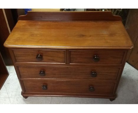 A 19th Century mahogany chest-of-drawers, two short over two long drawers, rounded corners, gallery top, stamped to top drawe