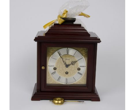Contemporary German mahogany mantel clock, moulded top with brass carrying handle, 15 cm square brass dial, cast spandrels, s