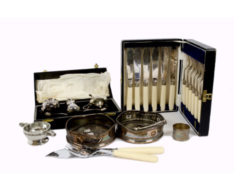 A collection of silver and silver plate, including silver napkin rings, silver sugar tongs, a pair of wine bottle holders, a 