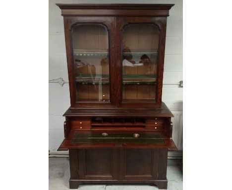 A 19th Century mahogany secretaire bookcase, upper section with two panel glazed doors and adjustable shelves, above fall fro