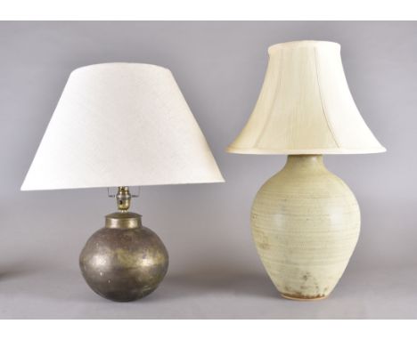 A stoneware ovoid table lamp, 33 cm high, tapered cream shade. Together with an Indian brass globular table lamp, 20 cm high,