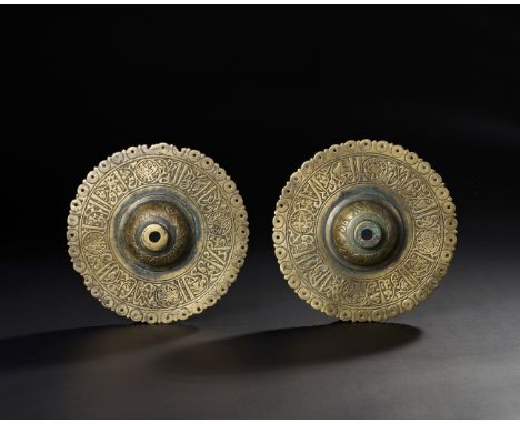    A pair of 13th century Persian Seljuk bronze door bosses, intricately decorated with Kufic calligraphy and arabesque motif