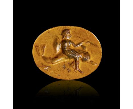 This exquisite Roman intaglio, carved from yellow jasper, dates back to the 2nd to 3rd century A.D. The intaglio features a f