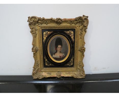 An early 19th Century miniature oil portrait of female with beehive hairstyle, gilt frame, 9cm tall 