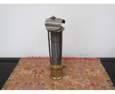 An American Davy-style miners lamp with brass base and steel flip top, stamped 'AM safety lamp, Scranton P.A'