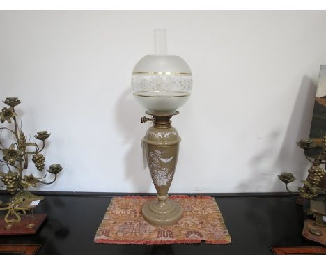 A Victorian glass oil lamp with drop-in font decorated with meadow flowers and butterfly in white enamel, garde A Duplex burn