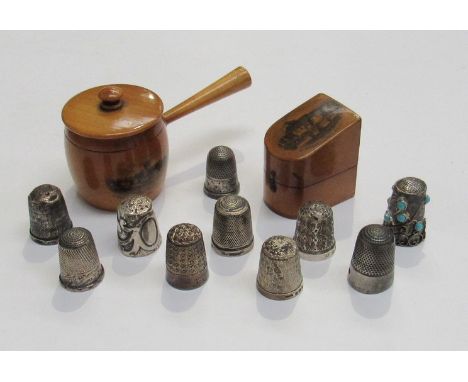 Nine silver thimbles including two Mauchline thimble cases and a stone encrusted thimble etc (12)