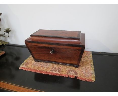 A Georgian mahogany tea caddy, 32cm long   