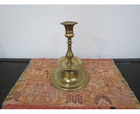 A 19th Century brass candlestick with drip tray, 23cm tall  