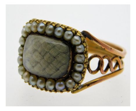 A 19thC. yellow metal mourning ring set with seed pearl, size R/S, 3.5g