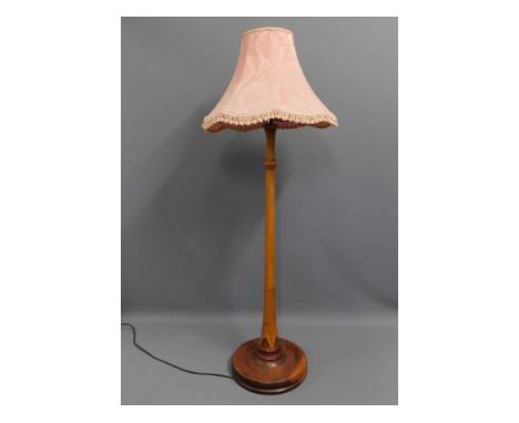 A wooden standard lamp, 66in tall to top of shade