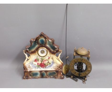 A pottery mantle clock, 12in tall twinned with a reproduction skeleton clock