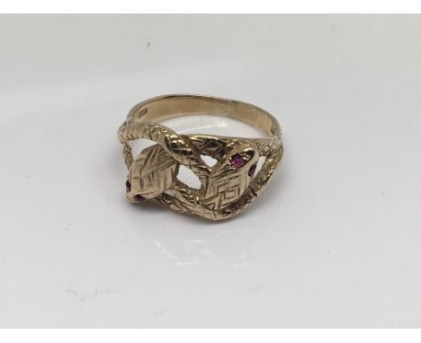 A 9ct gold ring in the form of two snakes with ruby eyes. Ring size R. Weight 4.5g 