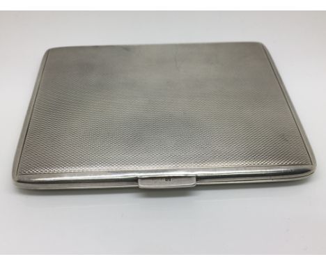 A silver cigarette case with engine turned decoration.