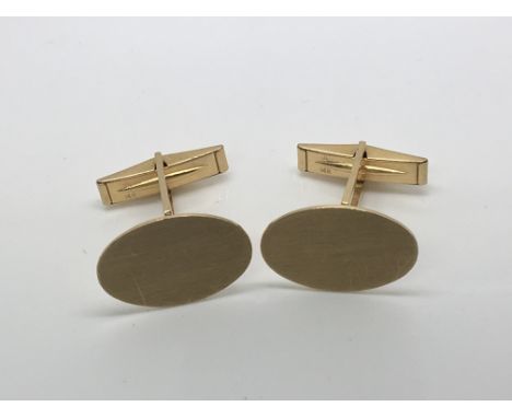 A pair of 14ct yellow gold cufflinks, both stamped 14k un-inscribed. Weight 6.9g approximately.