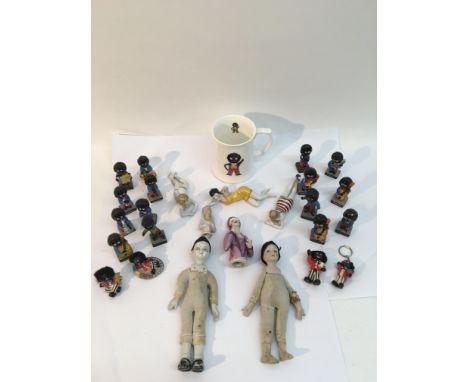 A collection of ceramic dolls and golly figures