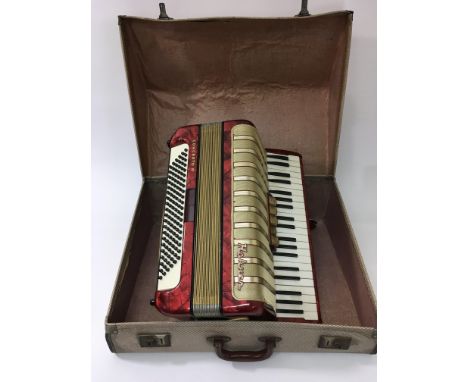 A cased Hohner Concerto IV accordion.