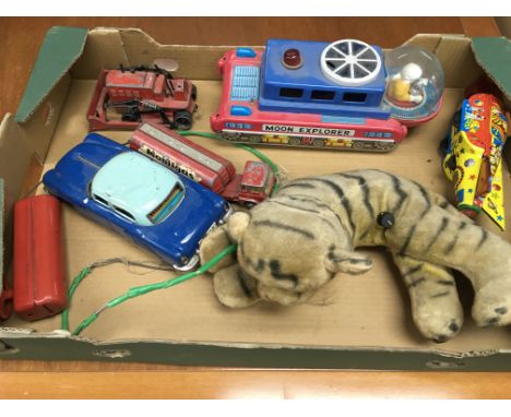 A box of toys including a tin plate moon explorer, Dinky bulldozer and other items.