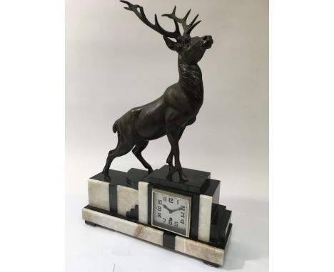 An Art Deco marble mantle clock surmounted by a bronzed figure of a stag, approx height 65cm.