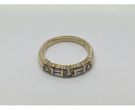 A 14ct yellow gold ring set with baguette and round cut diamonds, approx size N and 4.1g.