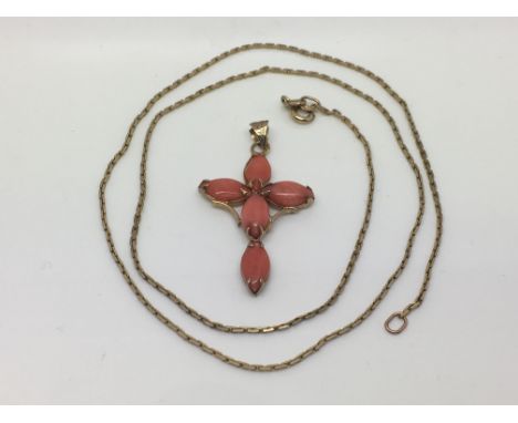 A coral pendant and a 9ct gold chain.