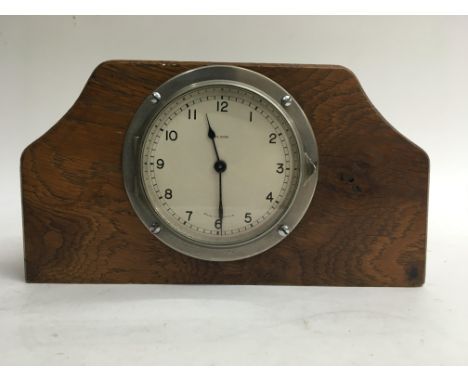 A British made car clock in an oak block.