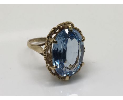 A yellow gold ring set with an aquamarine type stone, ring size N-O.