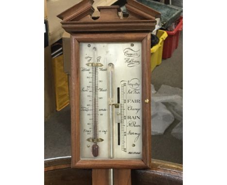 A 20th century mercury stick barometer, maker Comitti on a walnut frame with silvered dial.