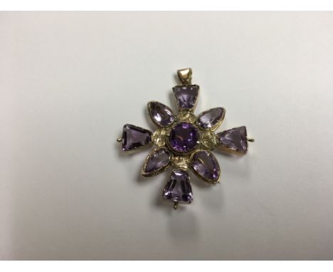 An antique gold and amethyst cross pendant / brooch.