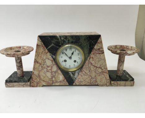 An Art Deco marble mantel clock with garnitures.